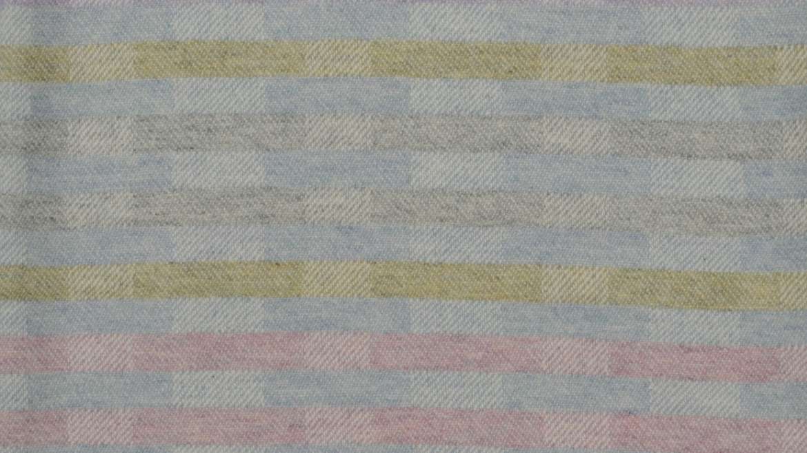 'Lineal' throw in soft lilac, pink, blue and grey showing reverse