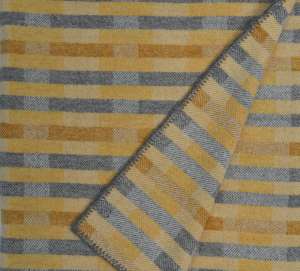 'Lineal' throw in soft ochre yellows and grey