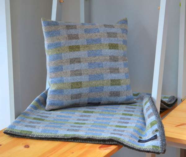 Handwoven 'Lineal' throw in blue, green and grey with cushion