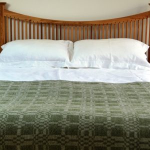 Handwoven throw by Madeleine Jude -'Coverlet' design in dark apple