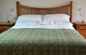 Handwoven throw by Madeleine Jude -'Coverlet' design in dark apple