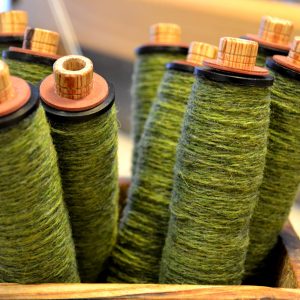 Green yarn on pirns ready for weaving