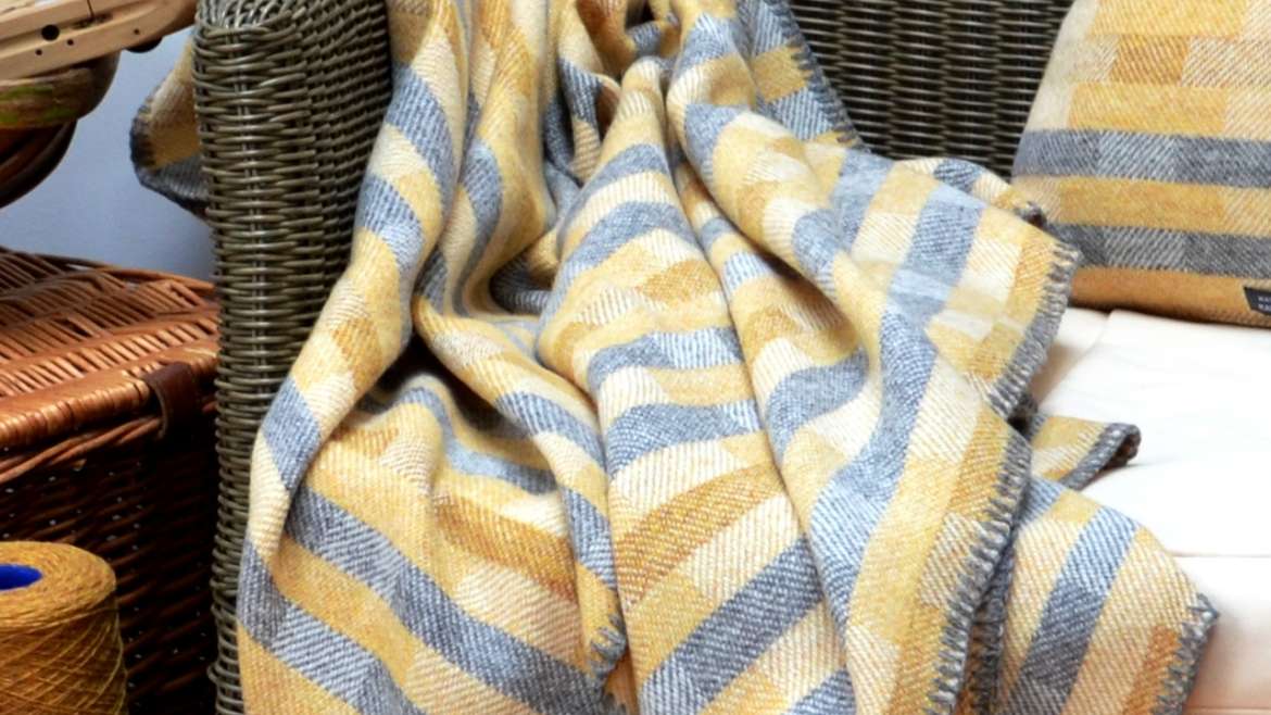 Lineal throw in saffron, ochre and grey
