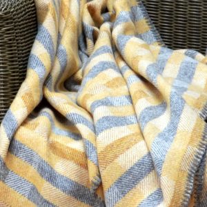 Lineal throw in saffron, ochre and grey