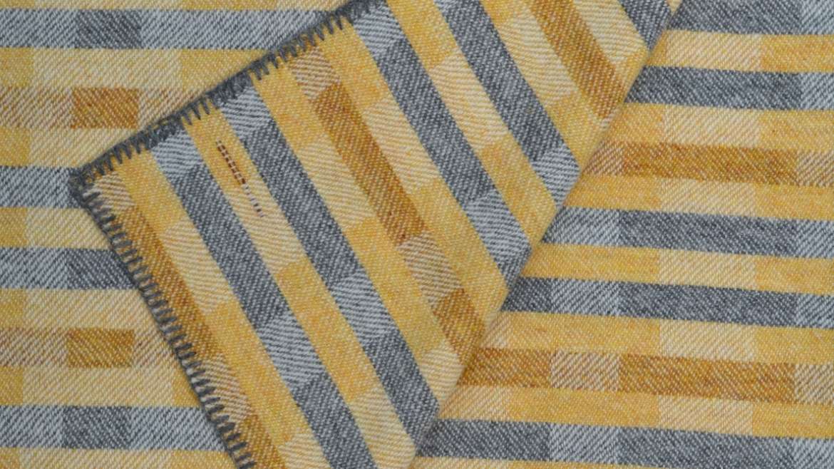 Lineal throw in saffron, ochre and grey